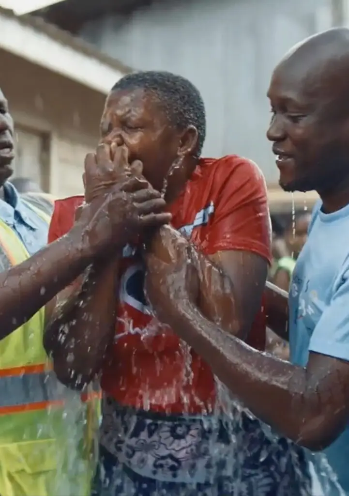 Kibera community members celebrating as clean water flows